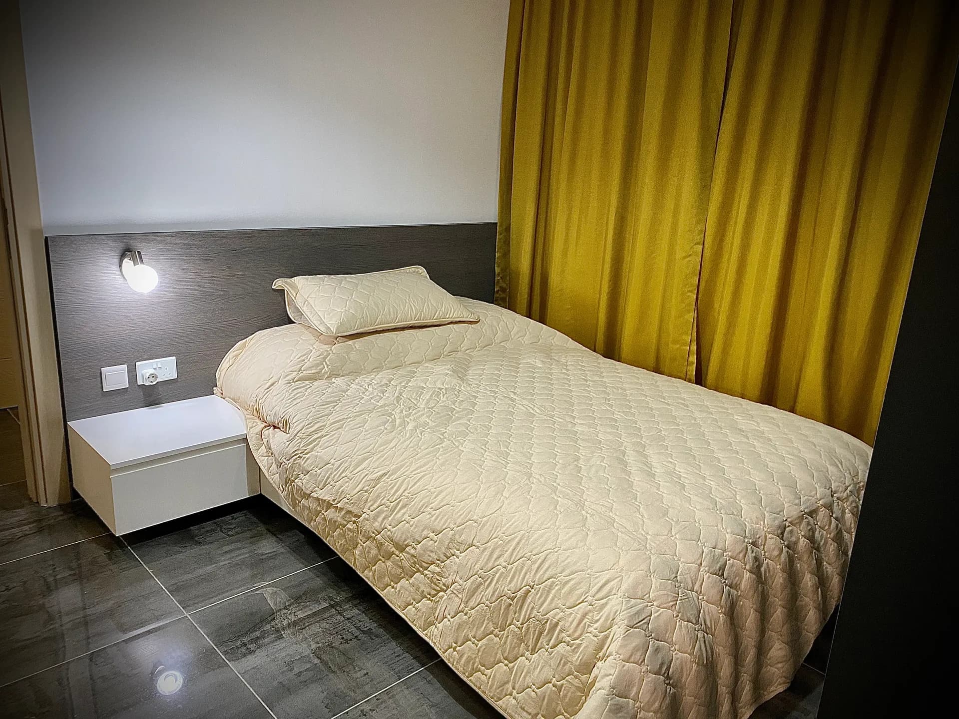 Sleeping area — reading light and bedside table
