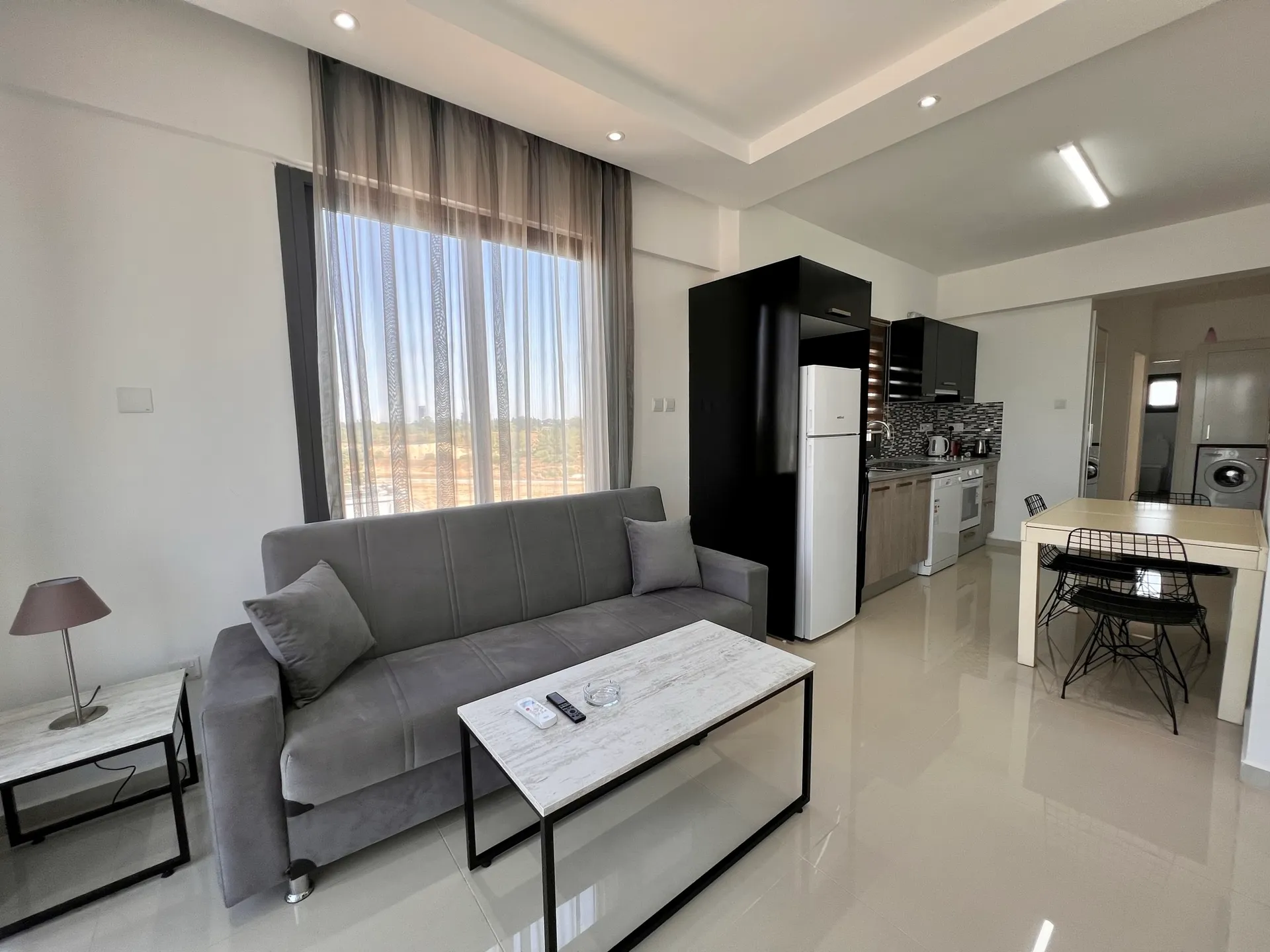 Living room and open kitchen with dining table